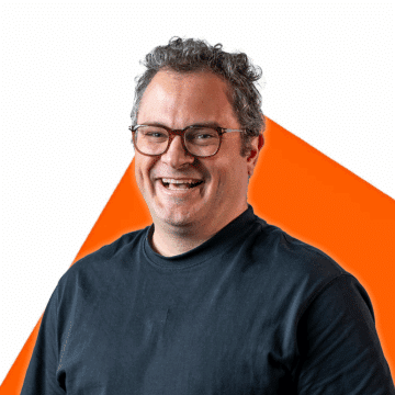 Portrait of Christian L'Heureux on an orange background