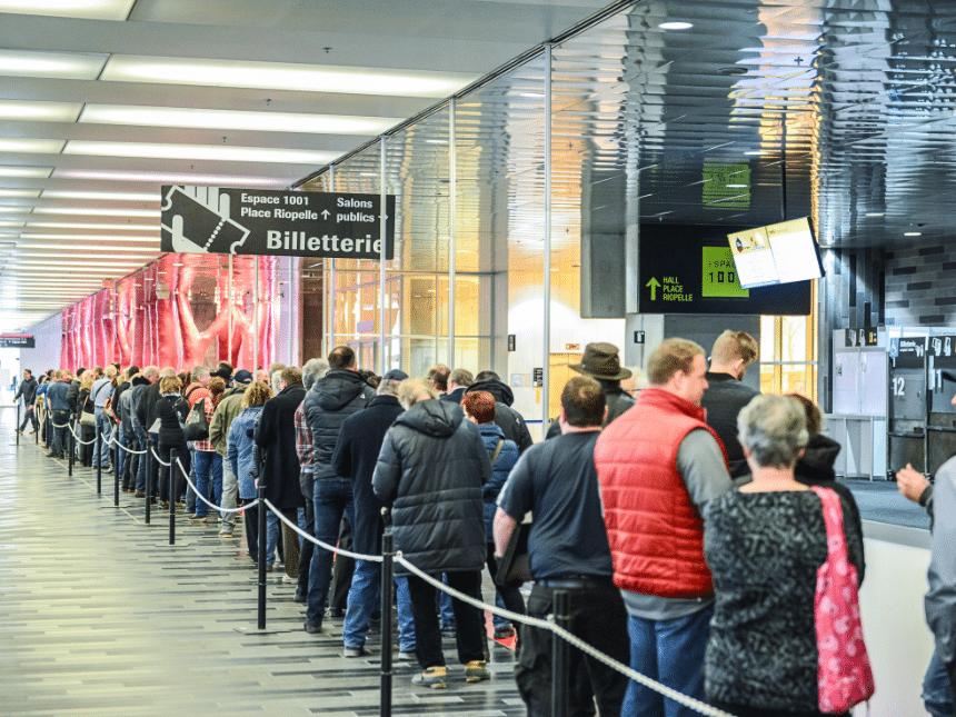 A line of people in the hall of the Palais des congrès de Montréal.