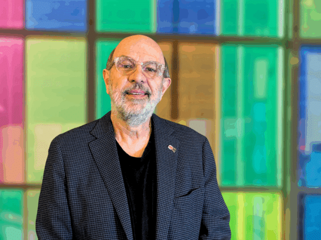 Portrait of Dr. Marc Steben, with the colored canopy in the background.